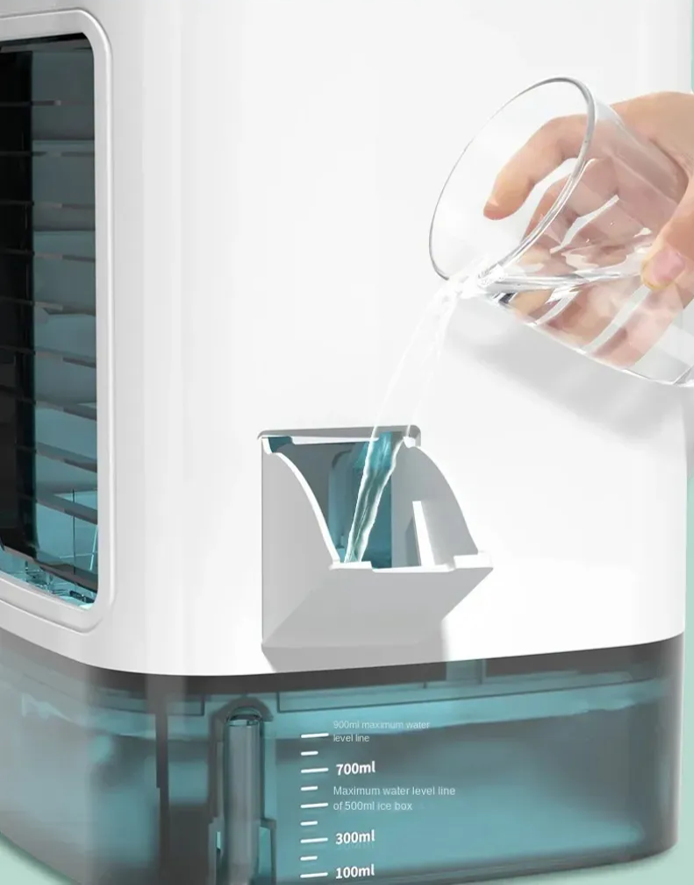 Hand pouring water into a humidifier with a clear container.